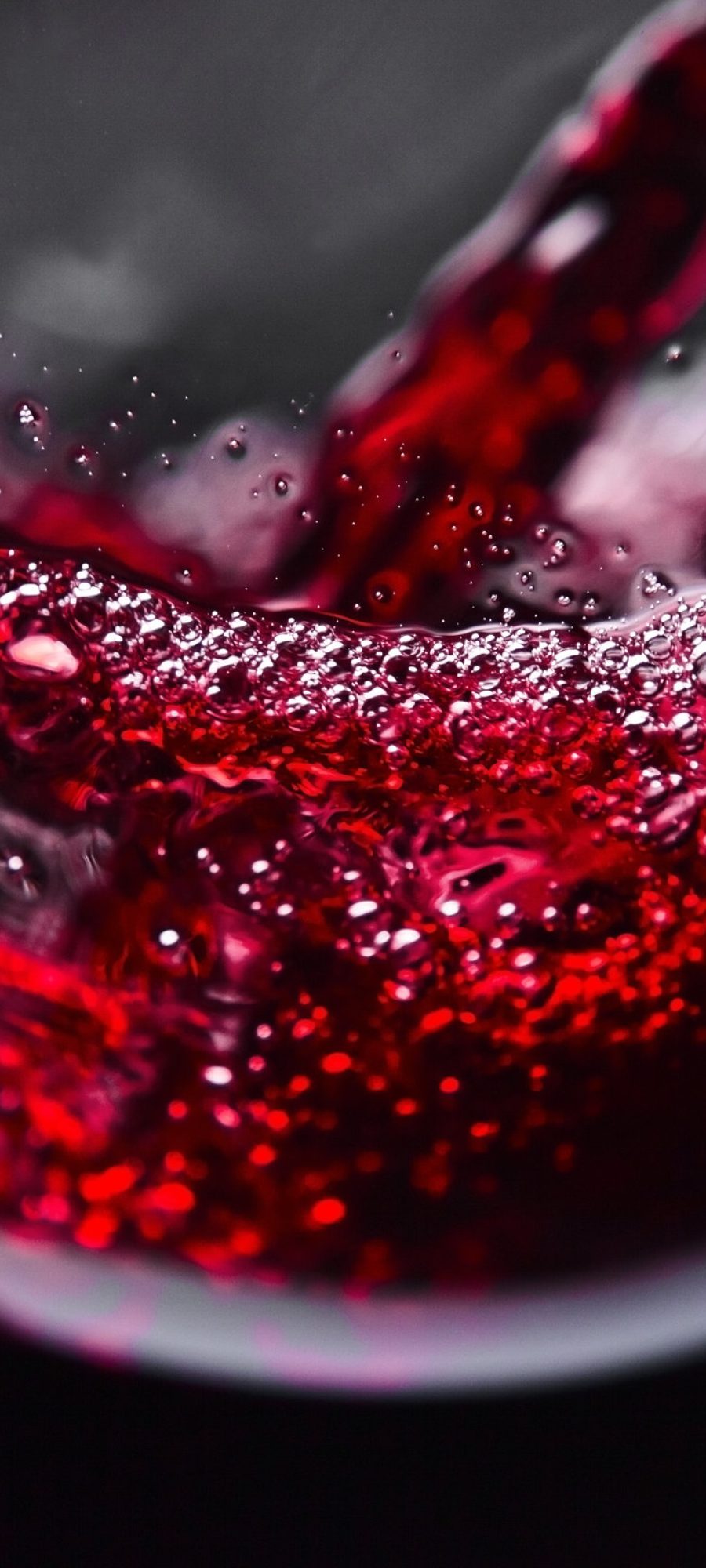 Red wine in wineglass on  black background